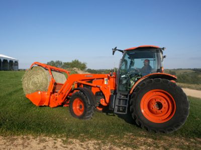 M135 tractor with hay grapple