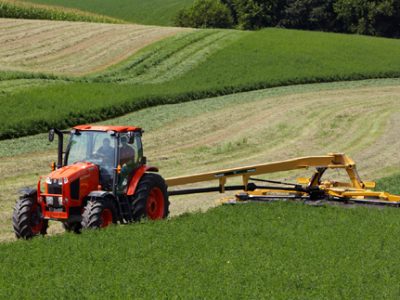 M135 large tractor with implement on back